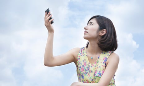 A young woman holding smartphone