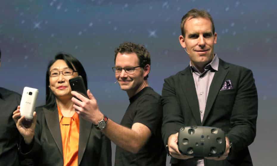 HTC marketing manager Jeff Gattis (R), shows off the Vive during a presentation at the Mobile World Congress in Barcelona
