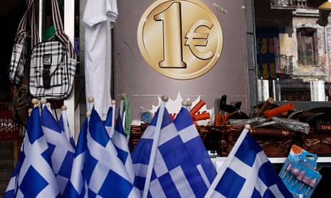 Greek national flags are displayed for sale at the entrance of a one euro shop in Athens