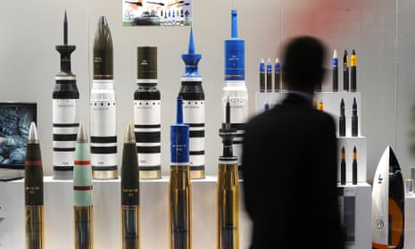 A man looks at tank ammunition at the Defence and Security Equipment International (DSEI) arms fair at the ExCeL centre in east London, on September 10, 2013. The arms fair describes it self as the world's largest fully integrated defence and security exhibition.