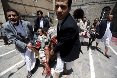 People carry injured people out of a mosque in Sana'a