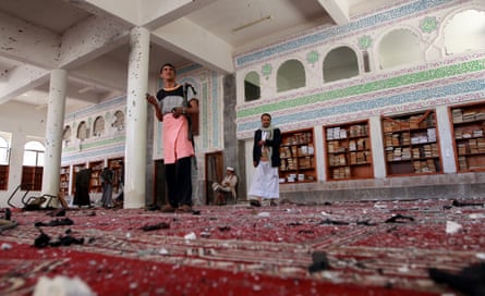 Armed men inspect the damage in Badr mosque