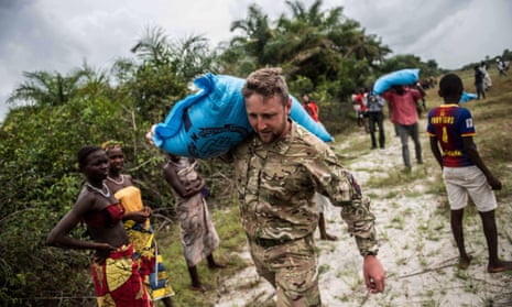 A British airman helps to convey food aid from the site of a helicopter drop to a village in the Turtle Islands, off the coast of Sierra Leone. British MPs want DfID to focus on bilateral aid spending.