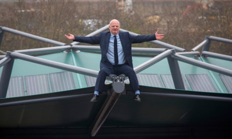 Perry Carroll, founder of The Solar Cloth Company, sits on a car park roof covered with his solar panels.