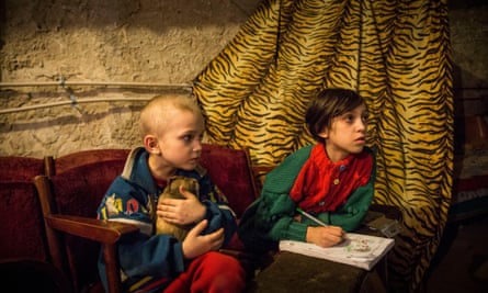 Pavel Makeev, left, aged five, and seven-year-old Raya Makeeva in the basement of a cultural centre in Donetsk’s Petrovskiy district where people have been living since June 2014.