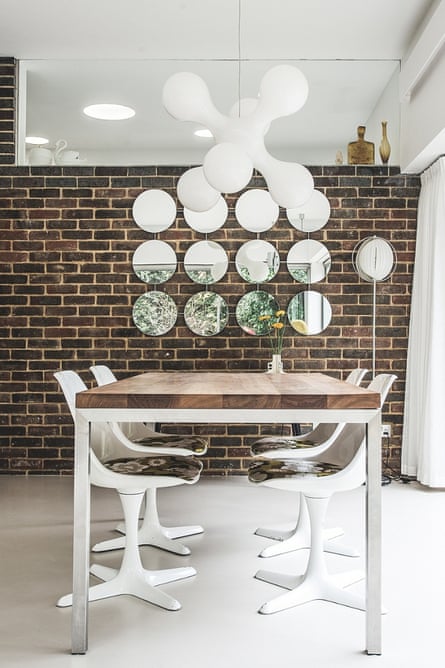 The Atomium pendant over the dining table is by Kundalini (from davidvillagelighting.co.uk); Wise made the circular mirrors on the brick wall himself – the kitchen is behind and can be glimpsed through glass pane.