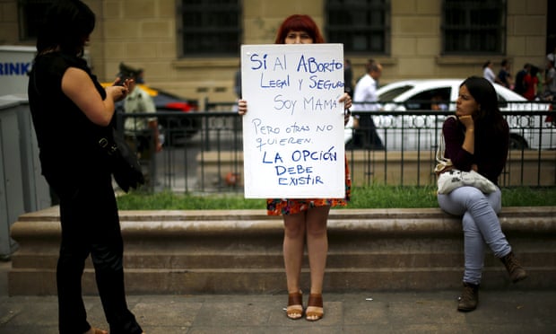 A woman holds up a pro-choice banner in Santiago, Chile, as the government considers a bill to ease the country's complete ban on abortion.