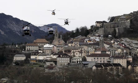 Helicopters of the French gendarmerie and emergency services fly over Seyne-les-Alpes.