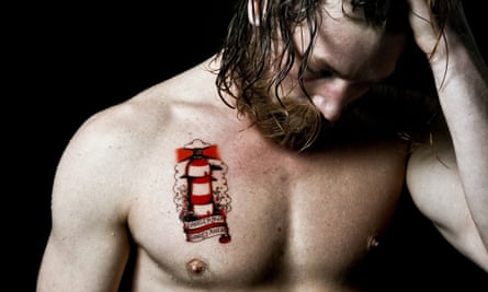 Surfer Ben Skinner with a tattoo highlighting the problem of marine pollution.