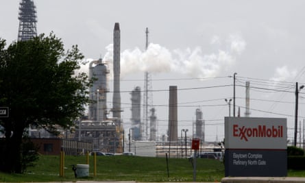 steam rises from towers at an Exxon Mobil refinery in Baytown, Texas