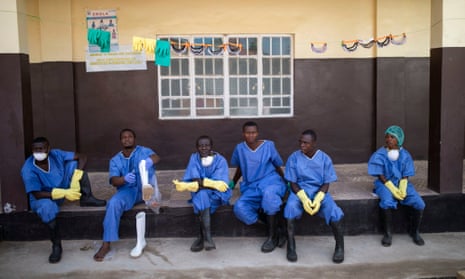 Health workers outside a quarantine zone at a Red Cross facility in the town of Koidu, Sierra Leone in December.