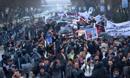 Afghan protesters hold banners as they shout slogans during a rally in front of The Supreme Court in Kabul on March 24, 2015, held to protest the killing of Afghan woman Farkhunda. More than a thousand people protested in the Afghan capital to call for justice after a woman was brutally killed by a mob who falsely accused her of burning a copy of the Koran.