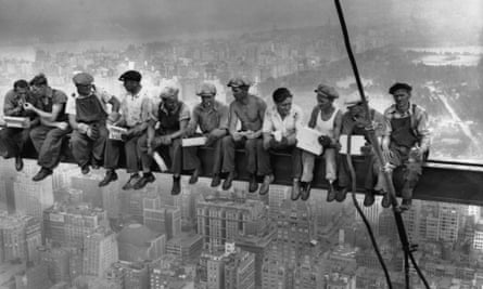 Construction workers eat lunch atop a steel beam, 800ft above ground, at the building site of the RCA Building in Rockefeller Center. Photograph: Charles C Ebbets/Bettmann/Corbis