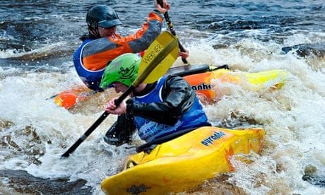Two people canoeing at the White water centre, at the Tees Barrage during a white water competition.
