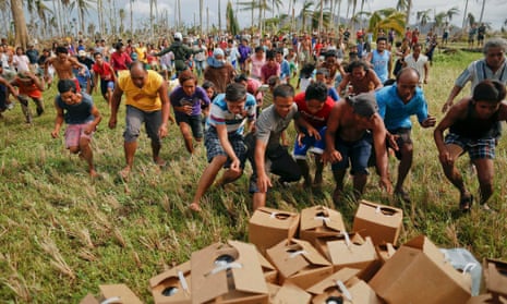Typhoon Haiyan survivors rush to grab water dropped by plane. 