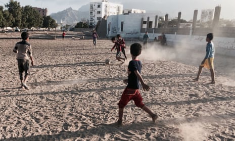 Children play football in Aden. The Yemeni port city is surrounded by rebels, with tanks guarding roads and children staying away from school.
