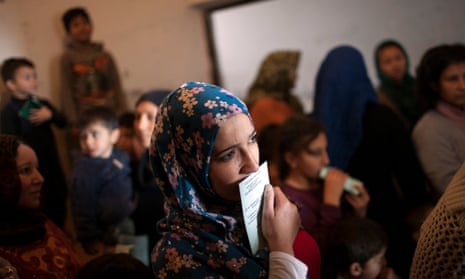 Syrian women wait as the Bulgarian Red Cross distributes medical supplies to refugees at a recently opened shelter in Vrazhdebna,