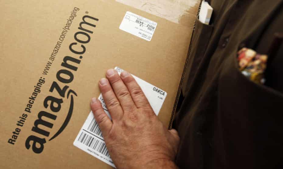 An Amazon.com package is prepared for shipment by a United Parcel Service driver in Palo Alto, California.