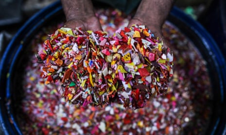 A worker washes shredded plastic waste for recycling in Mumbai, India.