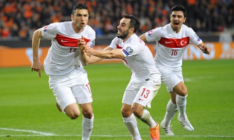 Turkey's Forward Burak Yilmaz (L) celebrates with teammates after scoring during the Euro 2016 qualifying round football match between Netherlands and Turkey at the Arena Stadium, on March 27, 2015 in Amsterdam. AFP PHOTO / JOHN THYSJOHN THYS/AFP/Getty ImagesFootballSoccer