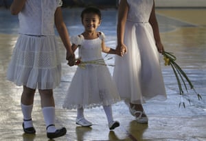 <strong>Quezon, Philippines </strong>With their best dresses on, girls join the Palm Sunday rites outside the Holy Family Parish church