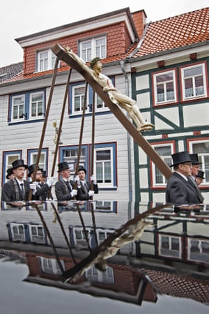 <strong>Heiligenstadt, Germany </strong>Believers are reflected in the roof of a car as they carry a cross of life-size figures from the Passion of Christ in front of several thousand people
