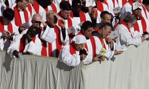 <strong>Vatican, Italy</strong> People shade themselves from the sun as the Pope preaches in St. Peter’s Square