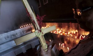 <strong>Managua, Nicaragua </strong>A Catholic holds a palm cross during a candle lit Palm Sunday ceremony at the Metropolitan cathedral