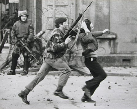 A paratrooper grabs a youth by the hair as he arrests him in Derry on Bloody Sunday.