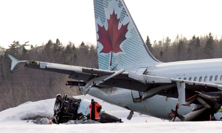 An investigator inspects the Air Canada plane.