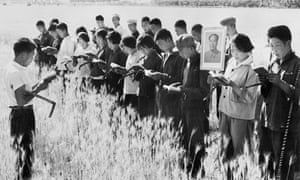 Peasants in the Chinese countryside in 1967 recite lines from Mao’s Little Red Book before starting work.