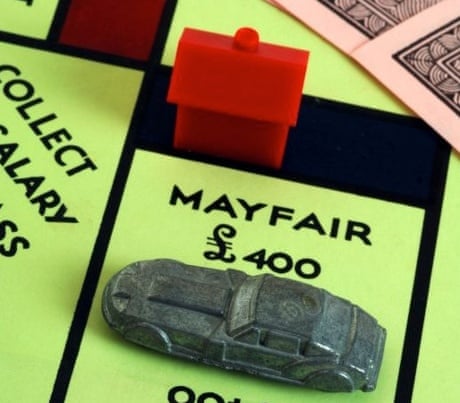 The car on Mayfair in a game of Monopoly, with a red hotel 