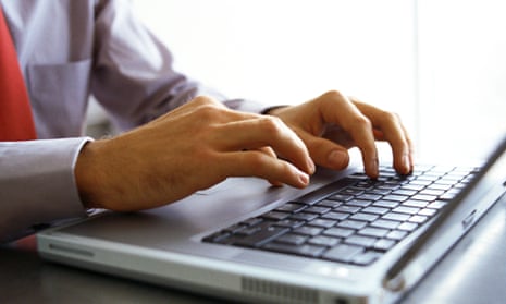 Man's hands on keyboard of laptop computer