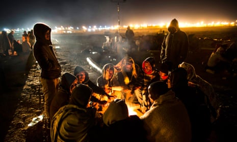 African asylum seekers gather around a fire during protests outside the Holot detention centre in the Negev