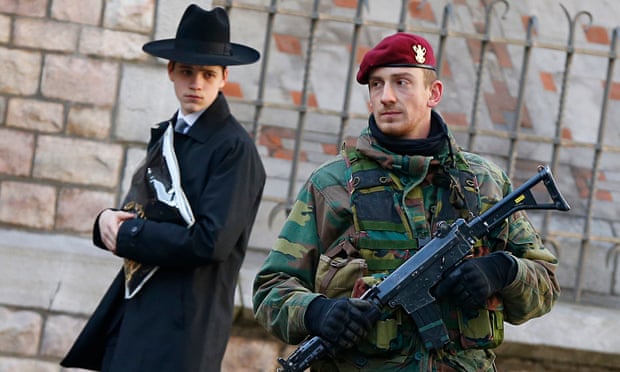 A Belgian paratrooper keeps guard outside a Jewish school in central city of Antwerp