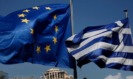 An EU and a Greek flag fly in front of the ancient Parthenon temple, in Athens