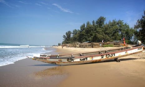 The beach at Abéné, Senegal, with fishermen’s shacks, some selling fresh seafood.