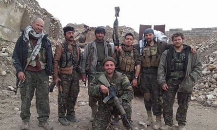 Kurdish and foreign fighters including British citizen Konstandinos Erik Scurfield, foreground in Sinjar, Iraq