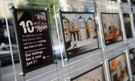 Promotional signs hang in a window of Jackson's estate agents in south London.