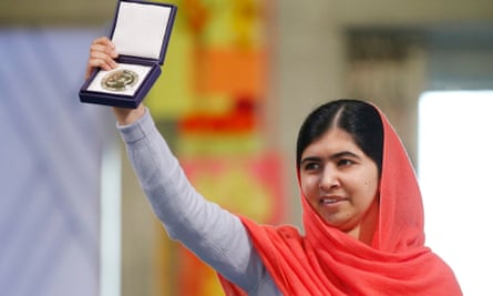 Laureate Malala Yousafzai displays her medal during the awarding ceremony of the 2014 Nobel Peace Prize at Oslo City Hall, Norway.
