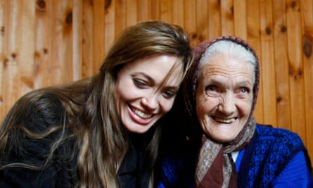 Angelina Jolie shares a laugh with Bosnian woman Babic Lena.