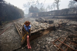 Eighty two year old resident Fran Collings sits amongst the remains of her destroyed home in Tokai