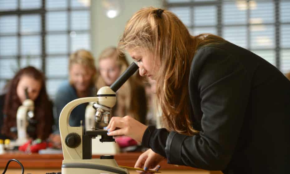 Pupils using microscopes during a science lesson at Pates Grammar School in Cheltenham