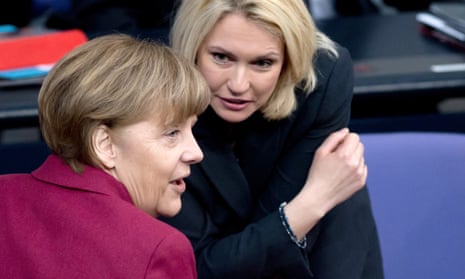 The German chancellor, Angela Merkel, talks to and women's minister Manuela Schwesig during a parliamentary session on Friday
