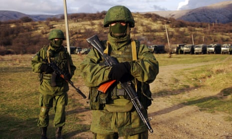 Russian forces pose as they block the Ukrainian unit in Perevalnoye, not far from Simferopol, on March 5, 2014.