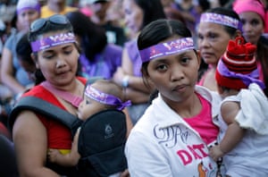 Filipino women with their babies participate a demonstration in Manila, Philippines