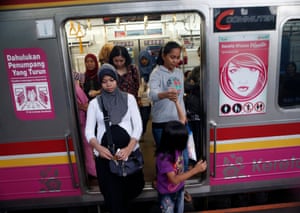 Indonesian women disembark from a commuter train carriage for women only at a station in Jakarta