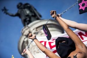 An activist of the women's movement FEMEN chained up with other members on the Place de la Republique in Paris