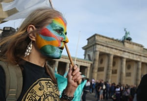 People march past the Brandenburg Gate  in Berlin