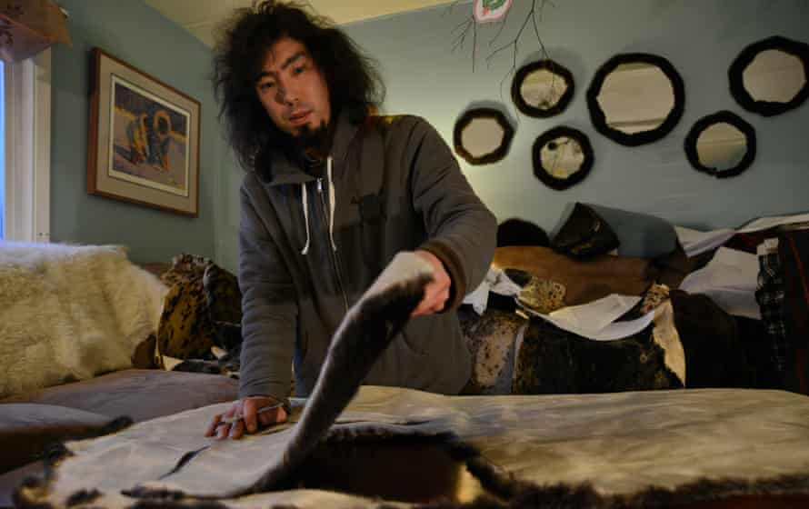Peter Williams making clothes from sea otter skin.